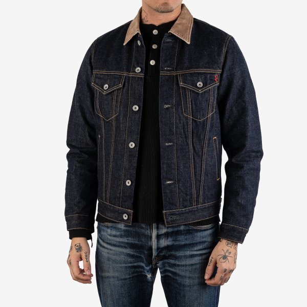 A man wearing Iron Heart fleece lined denim jacket with a corduroy collar, featuring multiple pockets and a button-up front.