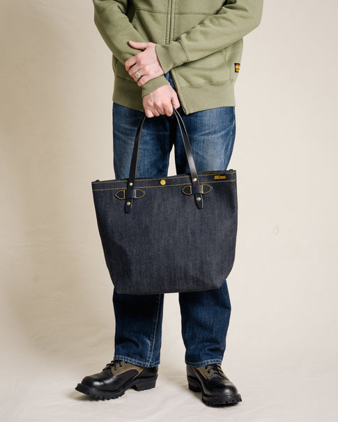 Person holding Iron Heart IHE-49 denim tote bag - handle and strap detail